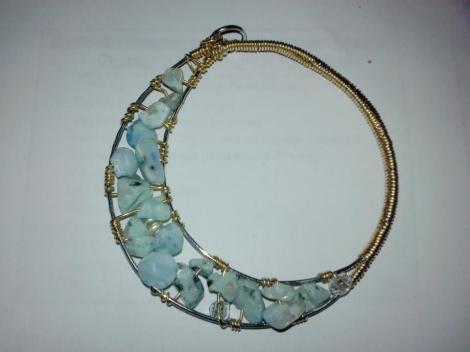 A sliver of a pale moon pendant.