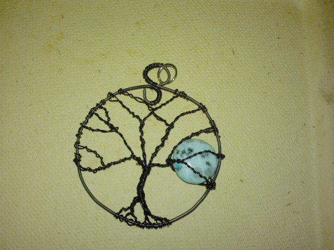 Moonrise through winter tree branches